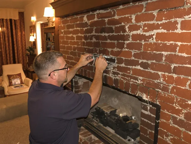 Clinton Chimney Sweep expert fixing a fireplace in Clinton, CT